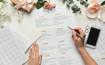 A woman holding a pen and looking over her wedding planning checklist to make sure she doesn’t break the bank.