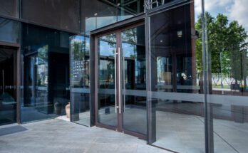 A commercial business with double-glass doors and vertical stainless steel handles for ADA-compliance.