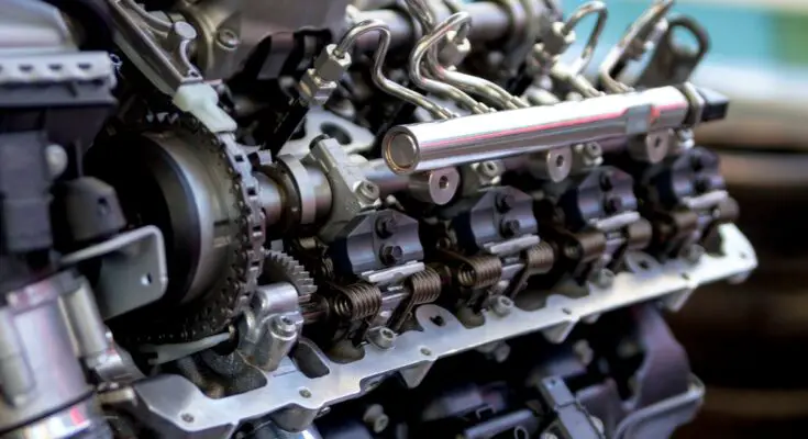 A close-up shows a diesel engine's common rail injection system with visible pipes, valves, and metal components.