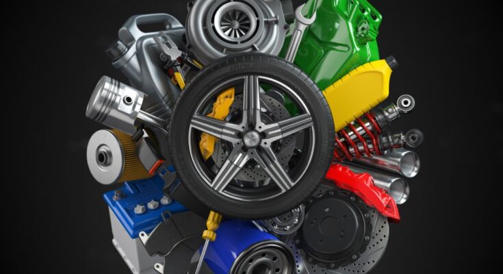 An assortment of car parts, spares, and automotive accessories is arranged and centered around a brand-new tire.