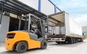 A forklift drives to the back of a semitruck to unload the cargo that was shipped across the country.